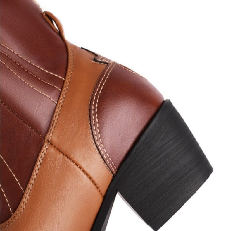 black cuban heel with brown-tan overlays and cream stitching.