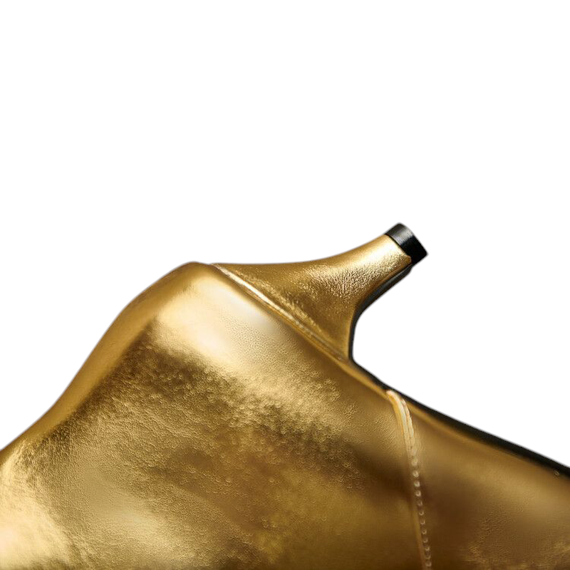 Detail of metallic-gold heel tab and stitching on boot back.