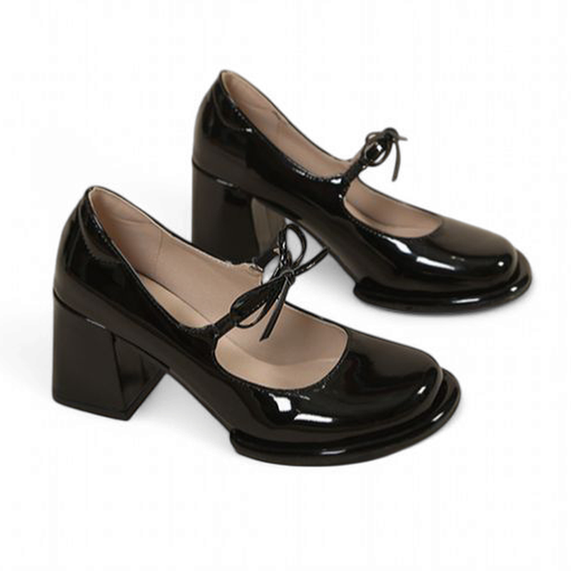 Side view of glossy black Mary-Jane pair with tall chunky heels on white background.