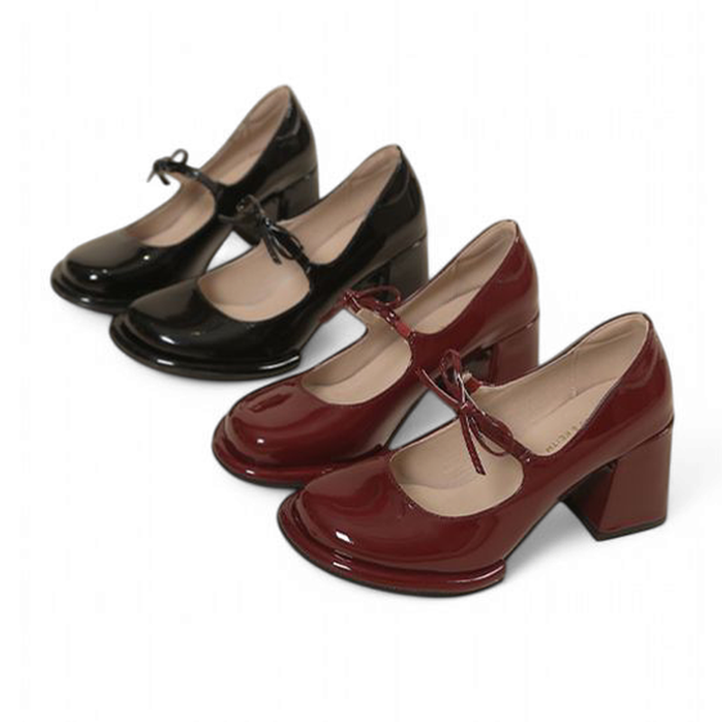 Single row of burgundy and black glossy pumps with chunky heels and front ties.