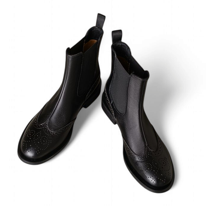 Black Chelsea boots angled pair view showing detailed front-side design