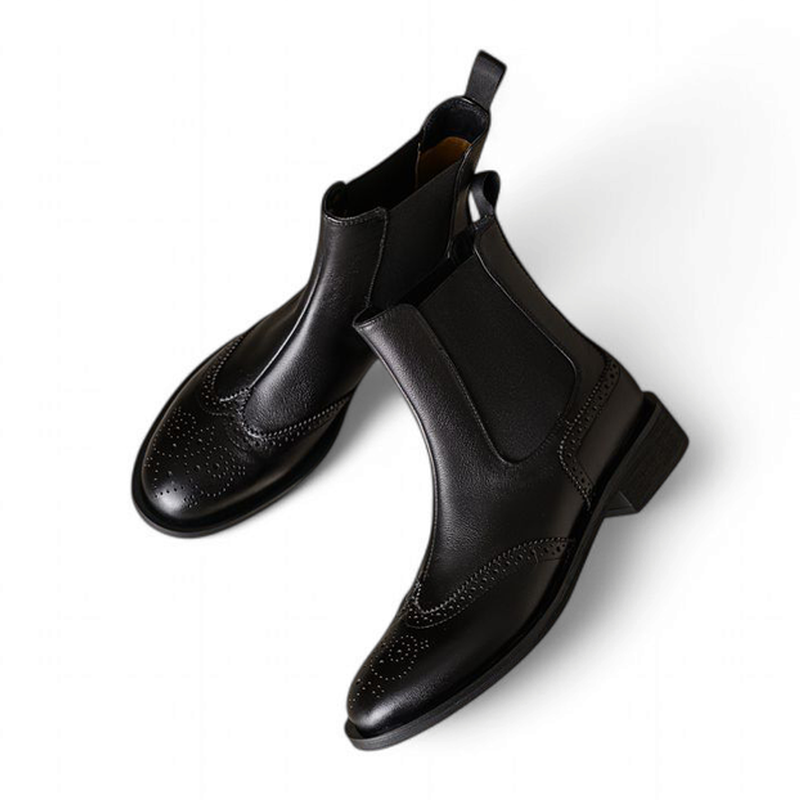 Angled top view of black Chelsea boots emphasizing structure and stitching