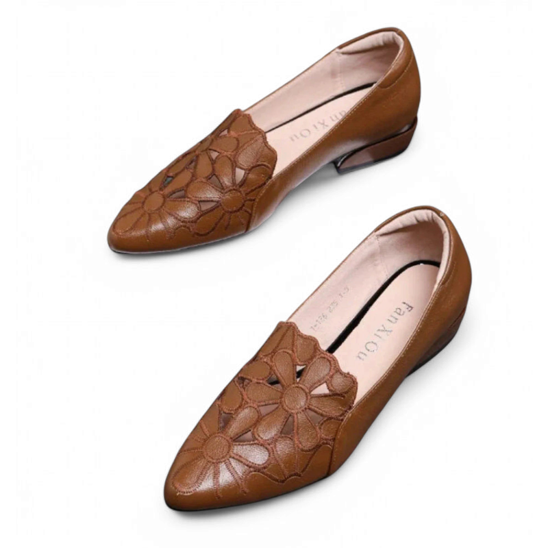 Angled pair of brown pointed low-heel flats on white background.