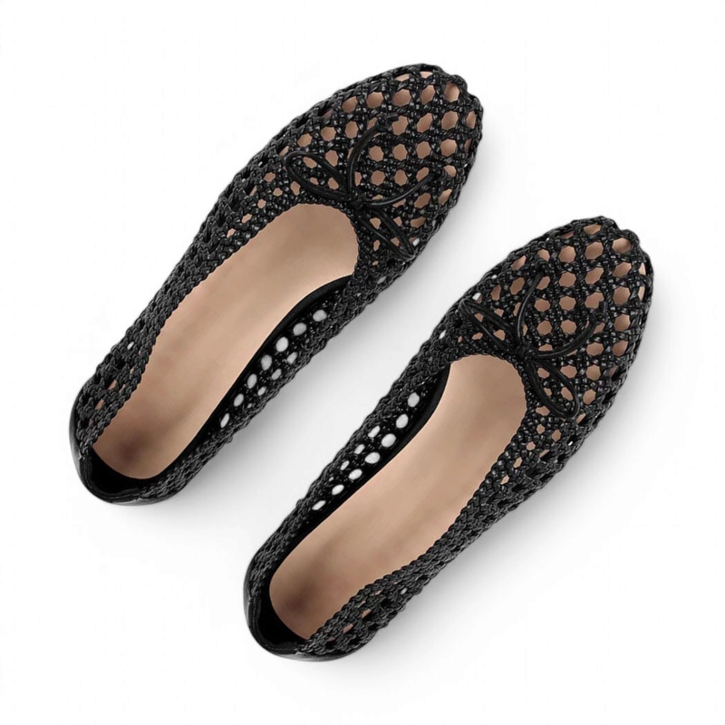 Top view of black mesh ballet flats showing beige lining and bow on the toe.