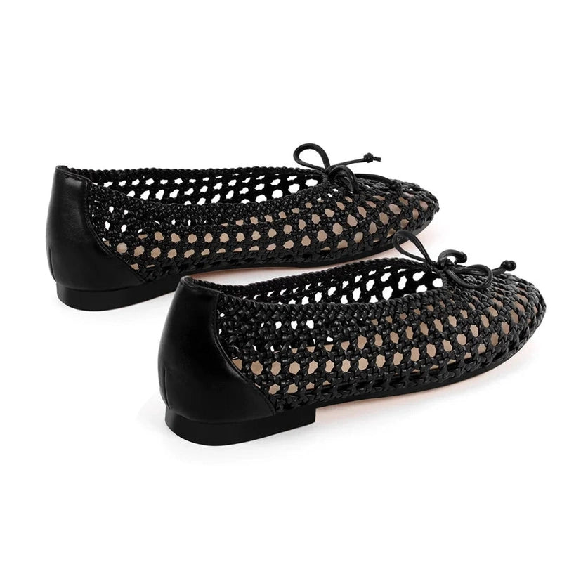 Pair of woven flats side-by-side with leather heel counter and flat base.