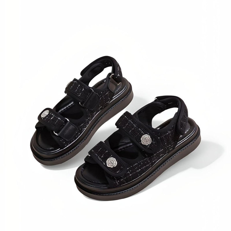 Angled view showing cushioned footbed and sling-back strap on black low-heel gladiator sandal.