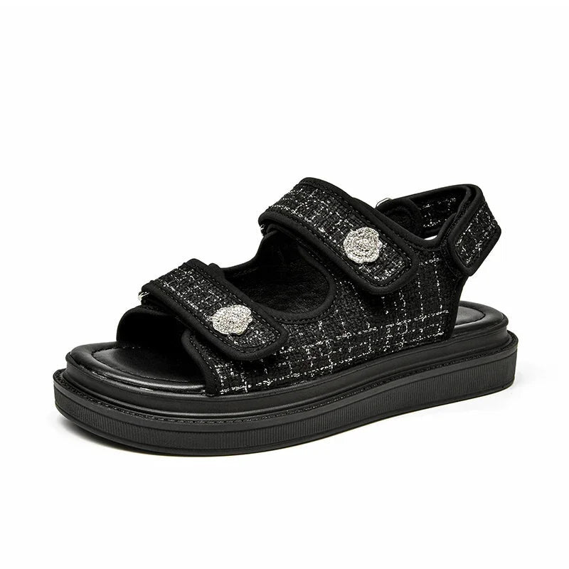 Side profile of black Atleta sandal highlighting tweed texture and 3 cm platform sole.