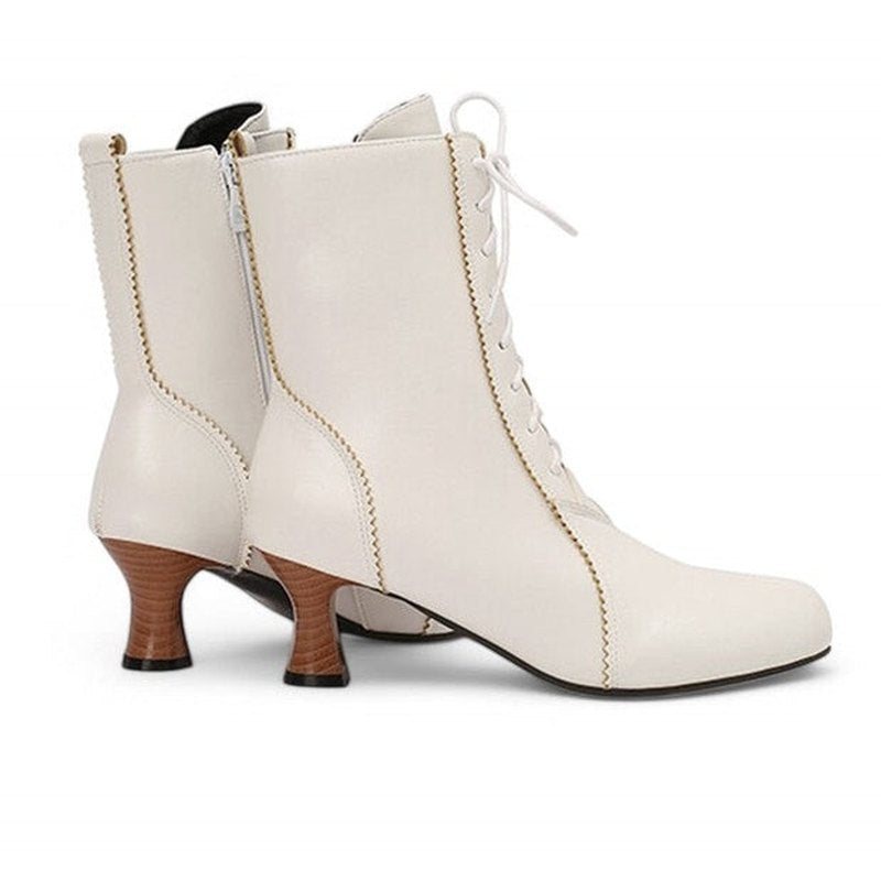 A single Merendy Samira white Victorian boot shown from the back. The image reveals the curve of the heel, rear stitching line, and the base of the square heel against a plain background.