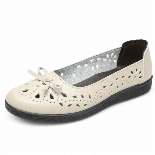 Beige single shoe angled side view showing round toe and black outsole.