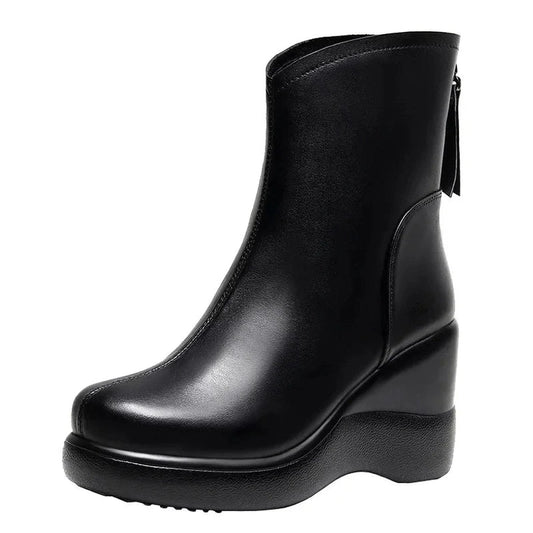 A black leather ankle boot with a square toe, wedge heel, and rear zipper, shown against a white background.