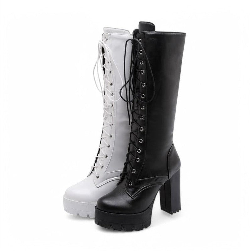 A pair of Victorian-inspired lace-up knee-high boots, one in black and the other in white, shown side by side with chunky platform heels.