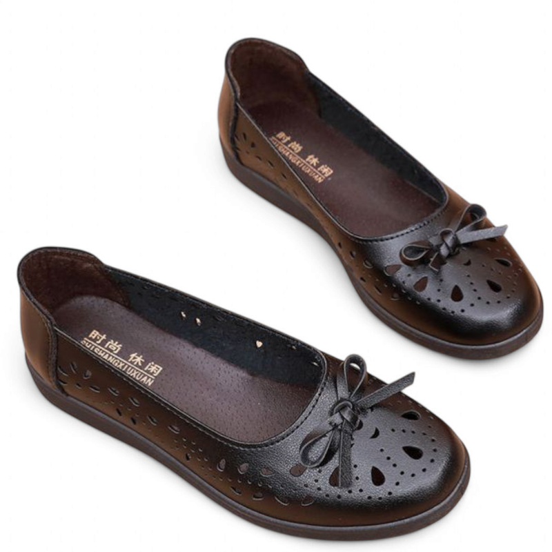 Black pair angled side view with gradated black sole and full perforations.