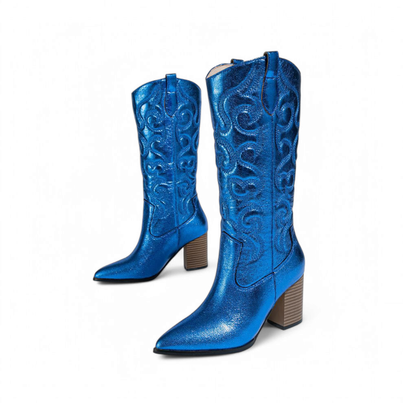 Shiny blue knee-high cowboy boots with swirling embroidery and brown block heels, angled view.
