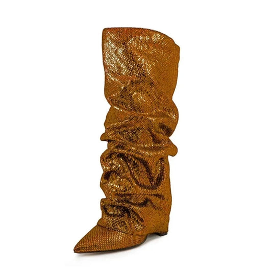 A single bronze knee-high boot with a jeweled texture, pointed toe, slouchy shaft, and hidden wedge heel, displayed on a white background.