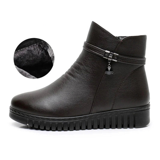 Side profile of a brown ankle boot showing zip and plush lining cut‑out.