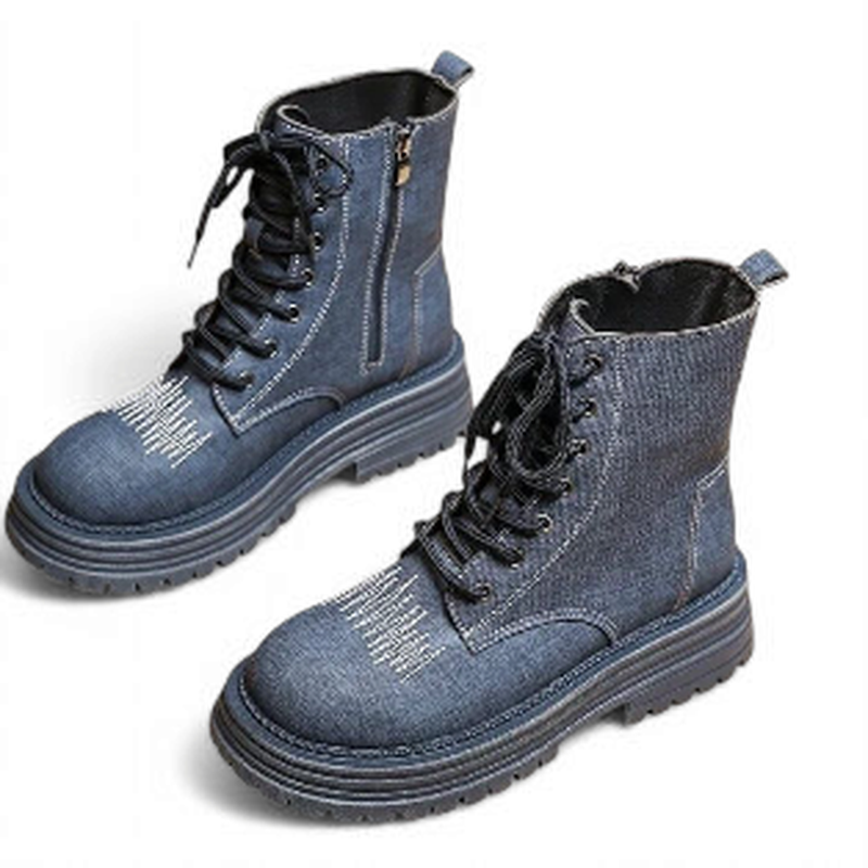 Pair of blue denim boots angled, highlighting contrast stitching.	