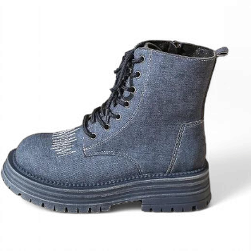 Left boot in mid-blue denim with white top-stitch and rubber outsole.