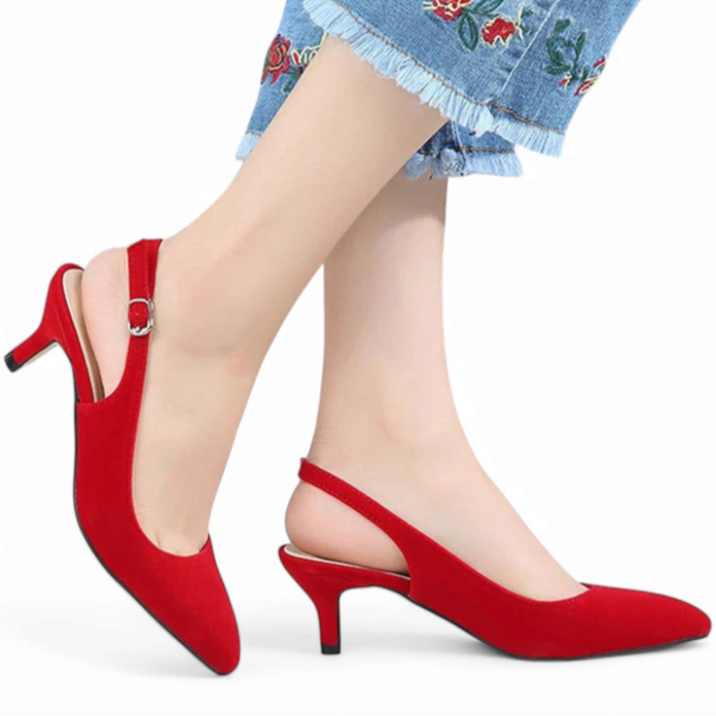 Red slingback kitten-heel pump with buckle worn by model in embroidered jeans, white background