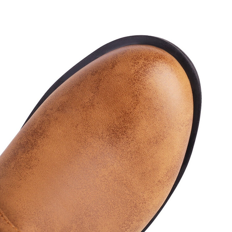 Close-up of a brown leather boot Toe on a white background