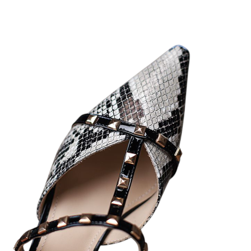 Detailed view of beige python pointed toe with black studded strap