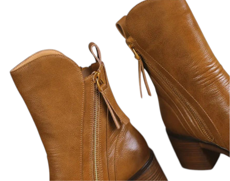 Prominent metallic zipper with brown leather upper on mid-calf boot

