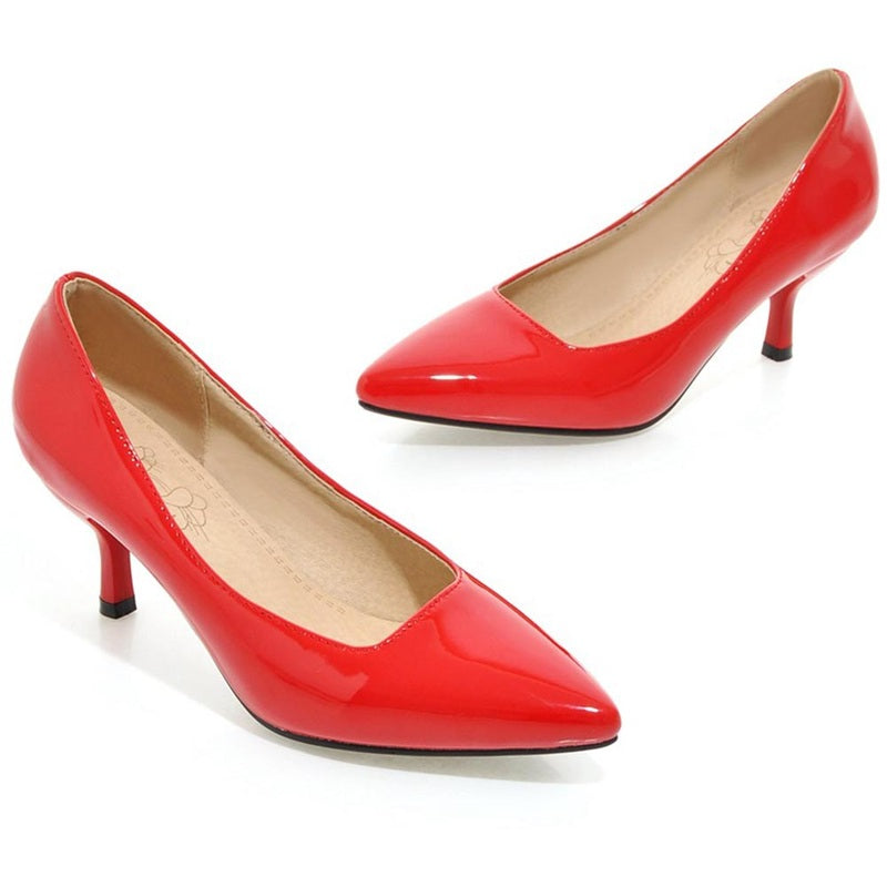 Angled side view of red glossy pointed-toe kitten-heel pair.
