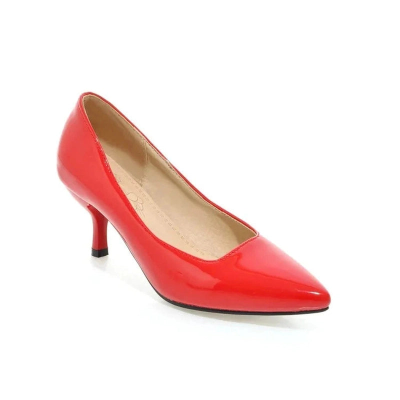 Glossy red kitten-heel pump with pointed toe and short heel, side view on white background.
