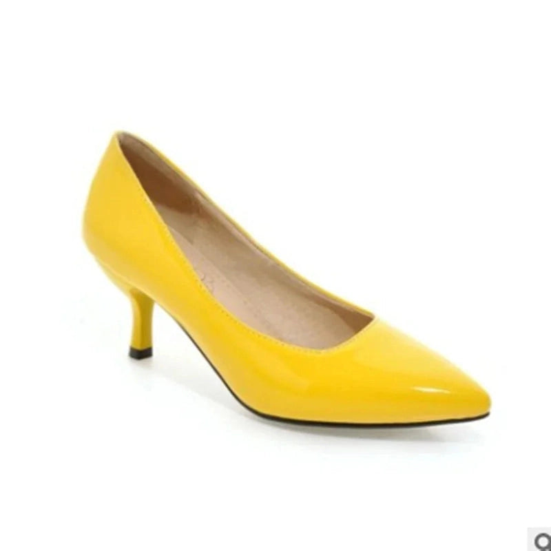 Glossy yellow kitten-heel pump, side view highlighting short heel.
