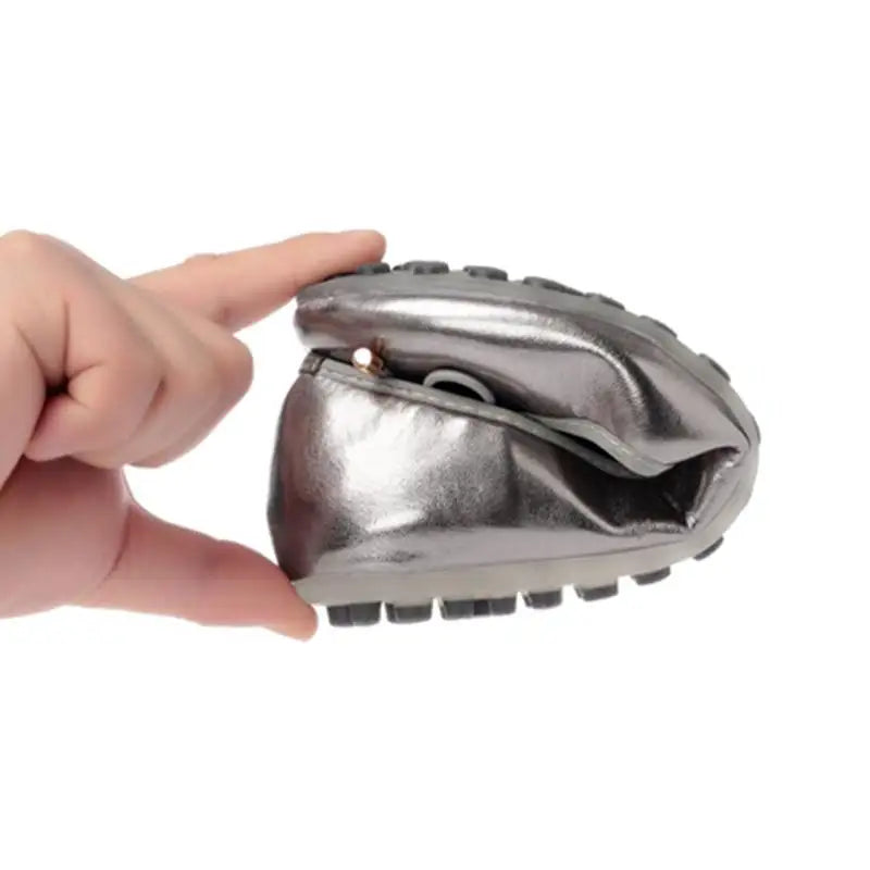 flat folded between two fingers to show flexible sole.