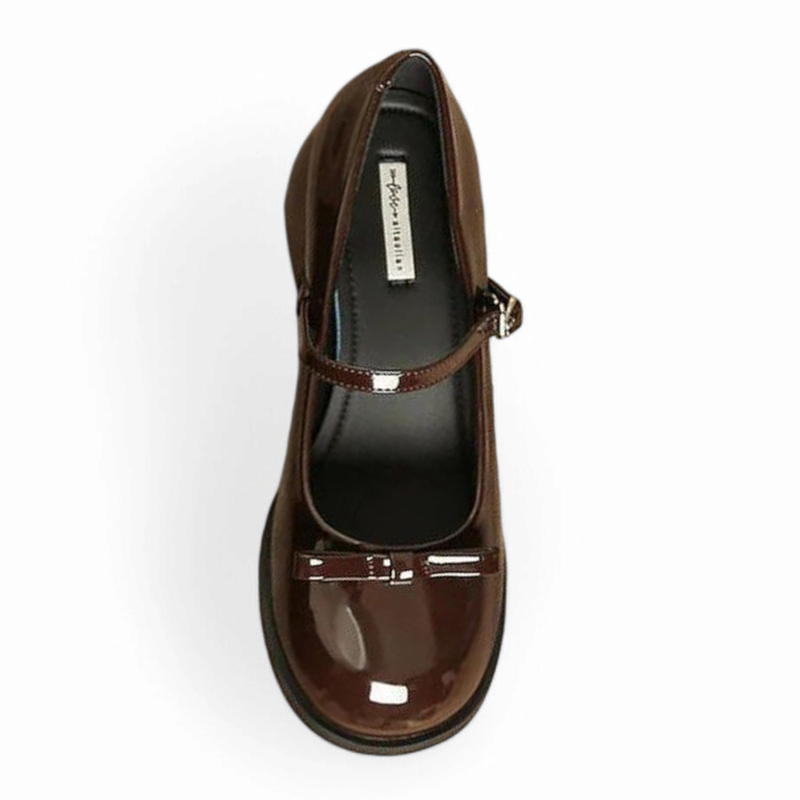 Top view of glossy brown Mary-Jane showing dark lining and strap.
