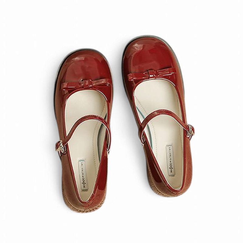 Top view of burgundy glossy pair highlighting strap and bow.