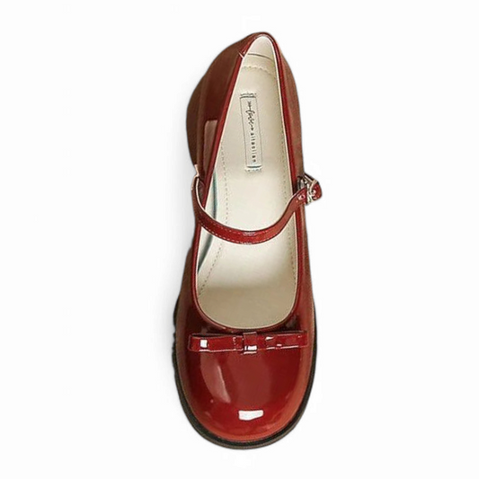 Top view of single glossy burgundy Mary-Jane highlighting bow and slim strap.