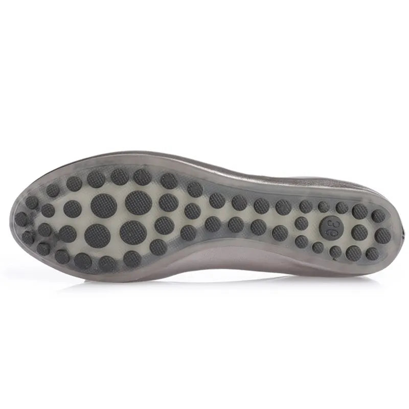 Close-up of translucent rubber sole with anti-slip dot pattern.