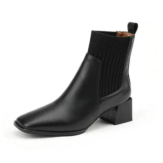 Side angle that reveals the sleek leather body, low ankle height, and bold 5cm heel.
