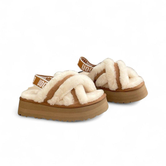 Pair of platform slippers with criss-cross faux fur straps and a branded elastic back band, shown against a white background.