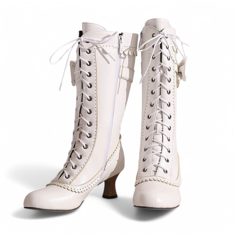 Front-facing view showing both boots side by side, with lace-up design, rounded toes, and elegant scalloped trim inspired by Victorian charm.
