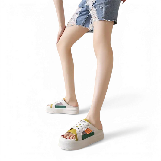 Multicolor platform slide sandal worn by a model in denim shorts, full-body view, white backdrop.