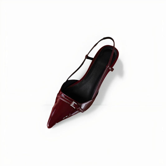 Top view of a glossy burgundy slingback pump featuring a pointed toe, a metallic front buckle detail, and a structured insole design.