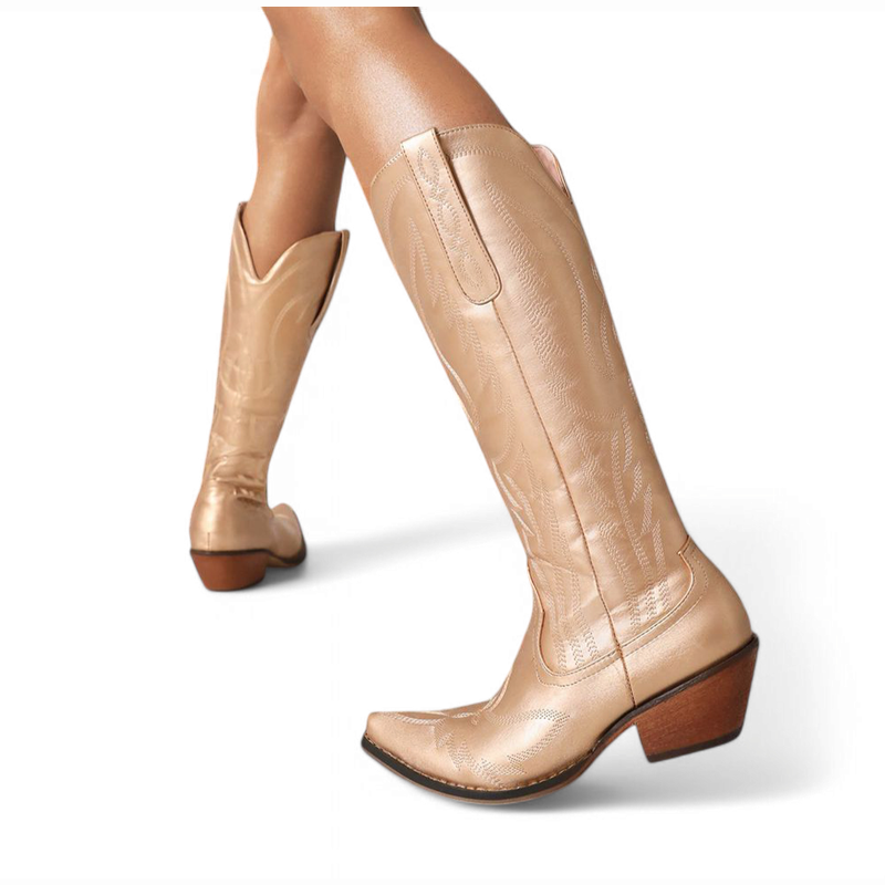 Metallic gold knee-high western boot with slanted block heel, shown on foot in a backward step.
