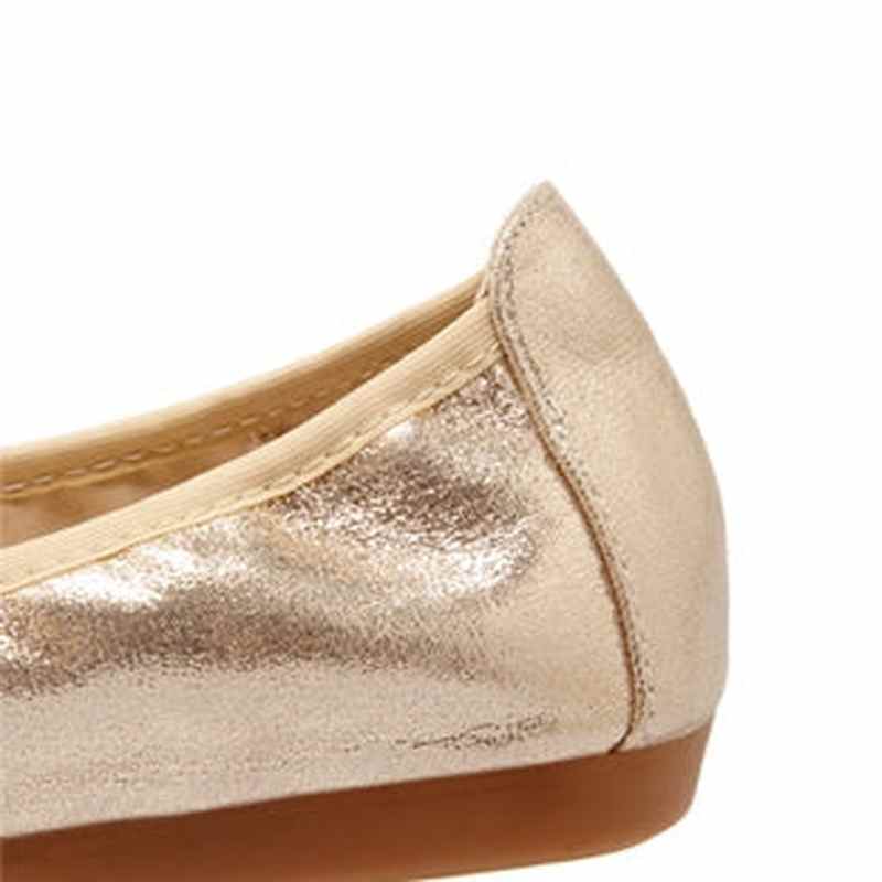 Close-up of the gold leather heel counter with stitched edge and elastic topline.