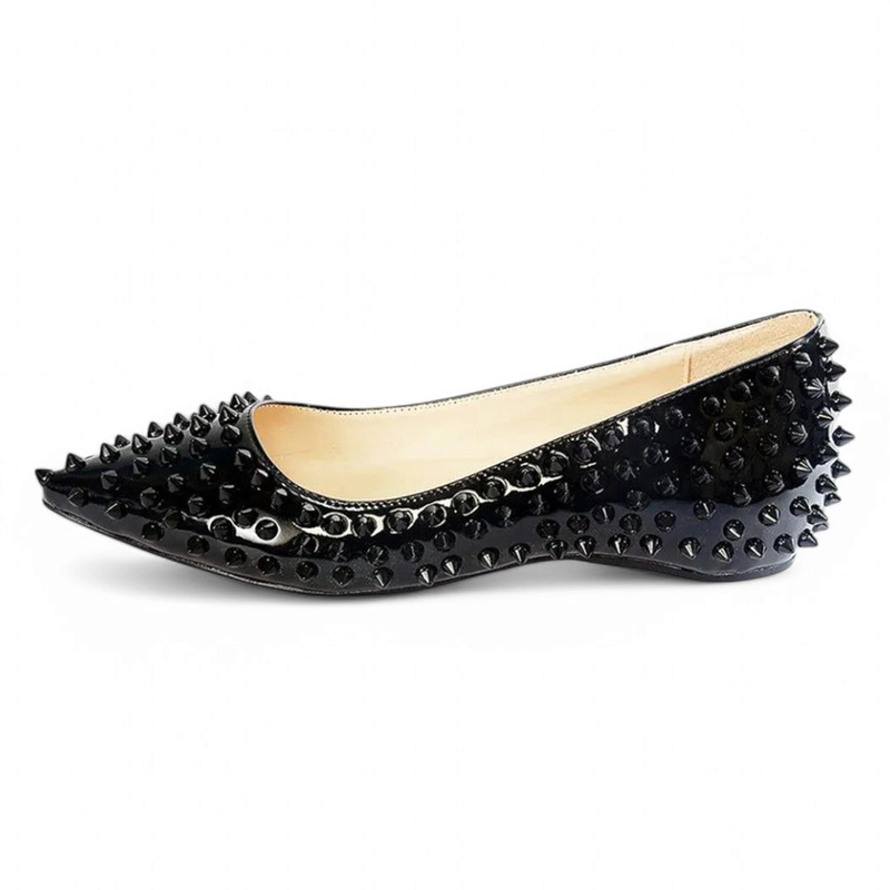 Shiny black ballet flat with black spikes covering the sides.