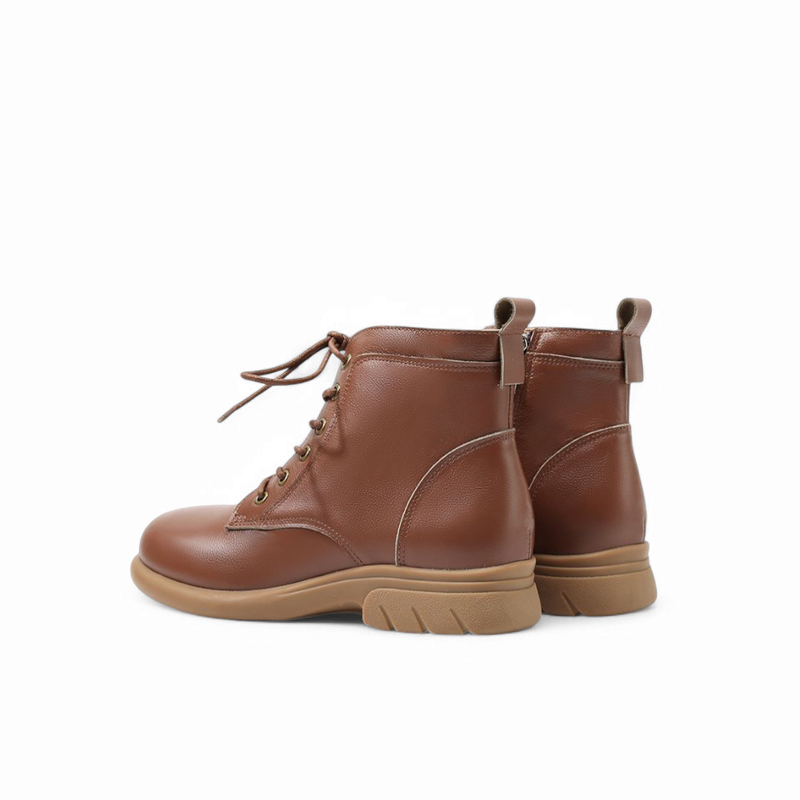 Back view of brown leather boots, showing heel design and upper collar details.

