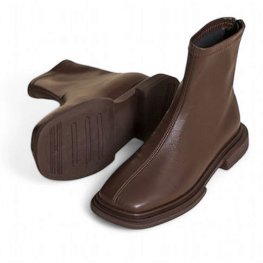 A pair of brown leather square-toe boots, with one boot tilted to show the detailed sole and the other upright.