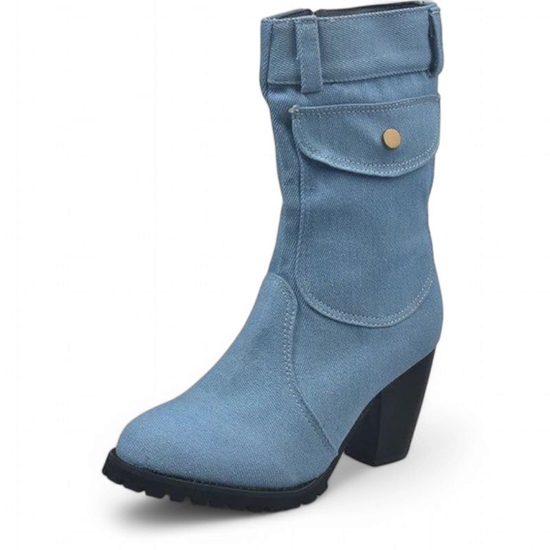 Light-wash denim ankle boot with rounded toe, flap pocket and chunky heel on white background.	
