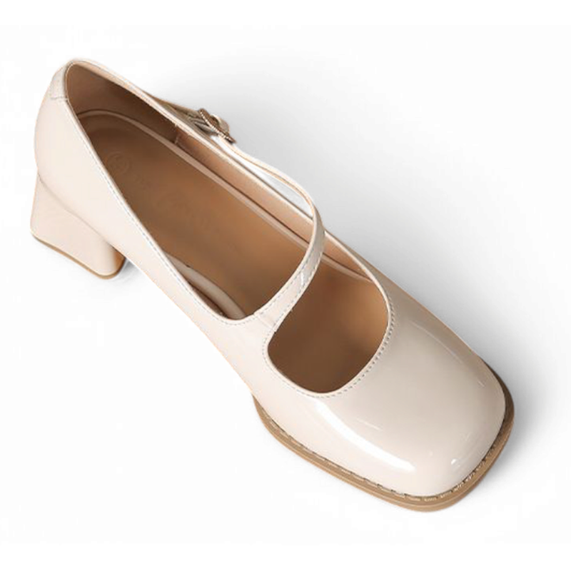 Single glossy beige Mary-Jane pump with block heel, angled top view on white background.








