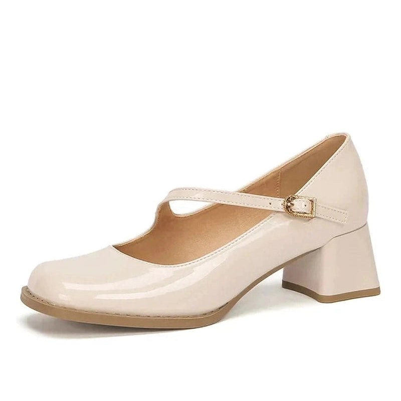 Glossy beige Mary-Jane pump with mid block heel, side view on white background.

