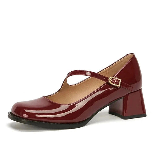 Glossy burgundy Mary-Jane pump with mid block heel, side view on white background.
