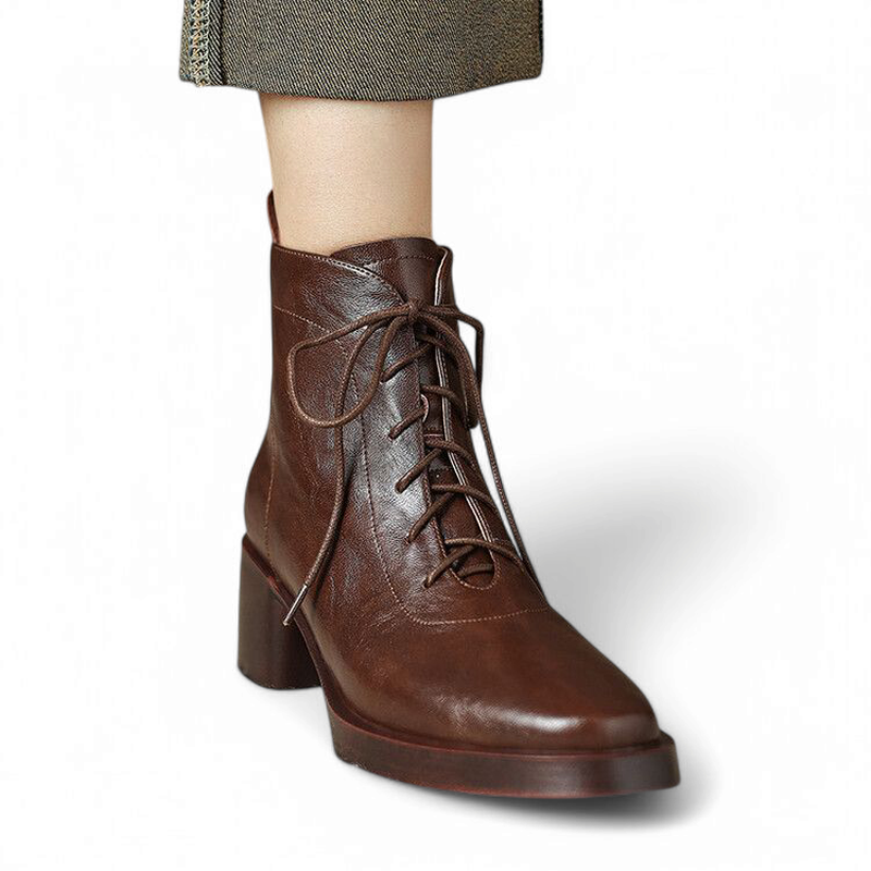 Front view of Merendy Tarek Victorian boots in brown split leather, featuring lace-up closure and detailed stitching, shown in a worn look.