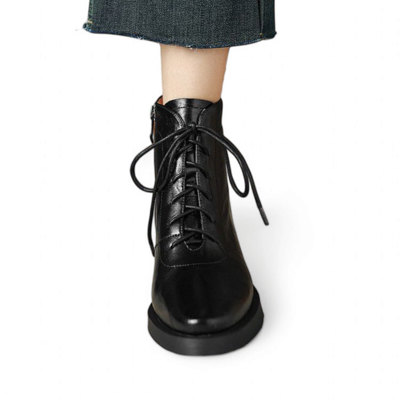 Front view of Merendy Tarek Victorian boots in black split leather, featuring lace-up closure and detailed stitching, shown in a worn look.