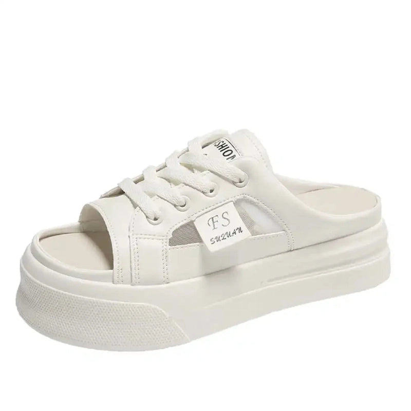 Static product shot of white lace-up low-platform sandal against a white backdrop